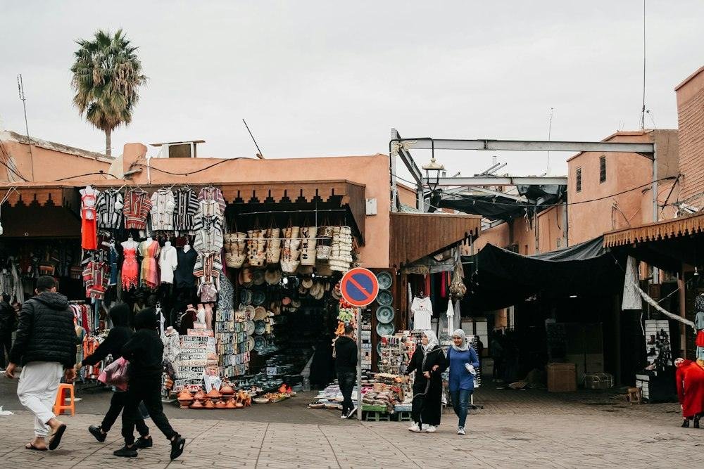 Busy souk street in Marrakech lined with rugs and lamps