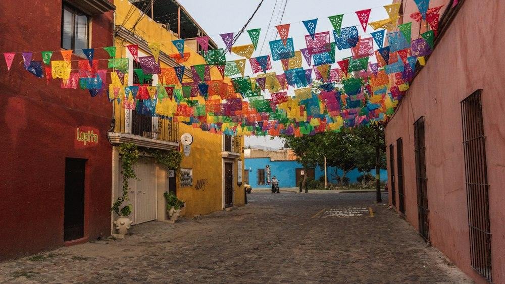 Colorful papel picado flags strung over a street in Oaxaca