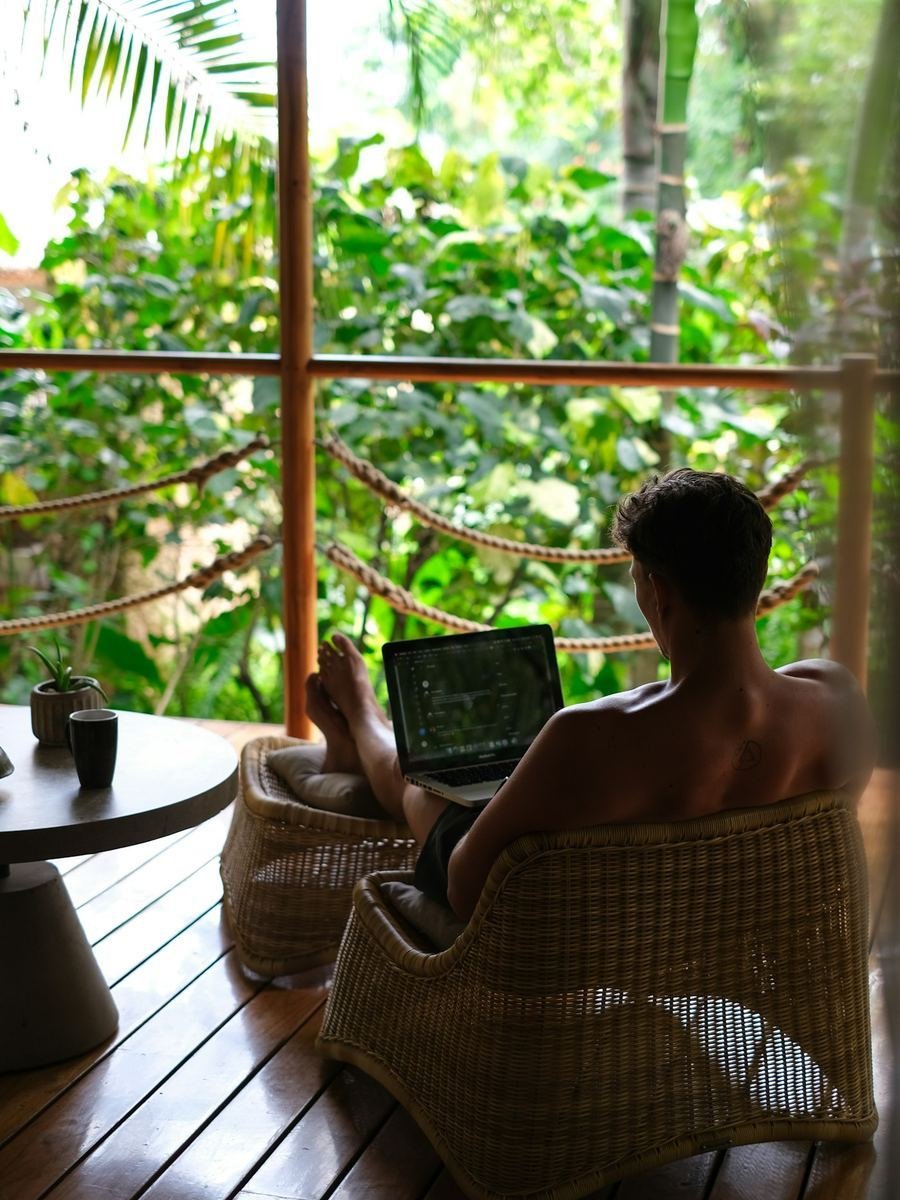 Laptop on a terrace surrounded by jungle